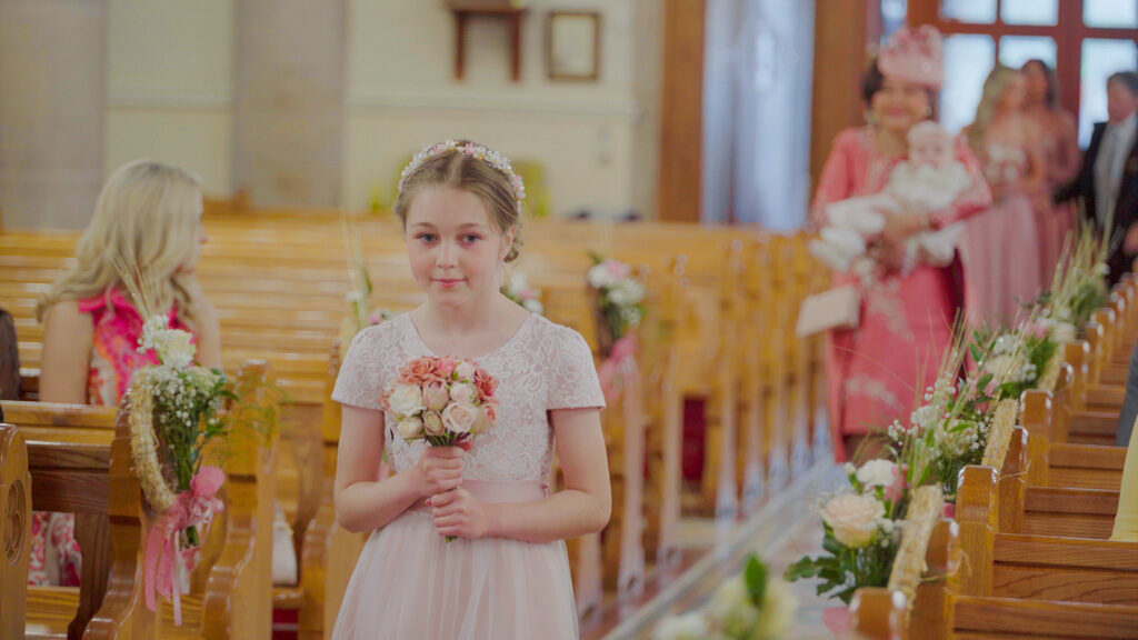 Bridesmaid during the wedding march captured in a Belfast wedding film